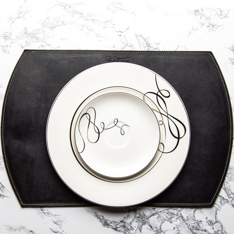 Straight Edged Oval Personalized Fine Leather Placemat in black with decorative plate and elegant design.