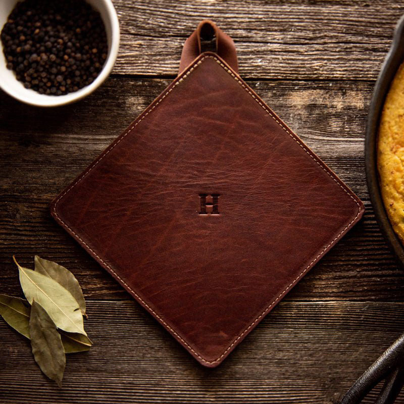 Leather trivet in rich brown, American made, perfect for protecting surfaces from hot pots.