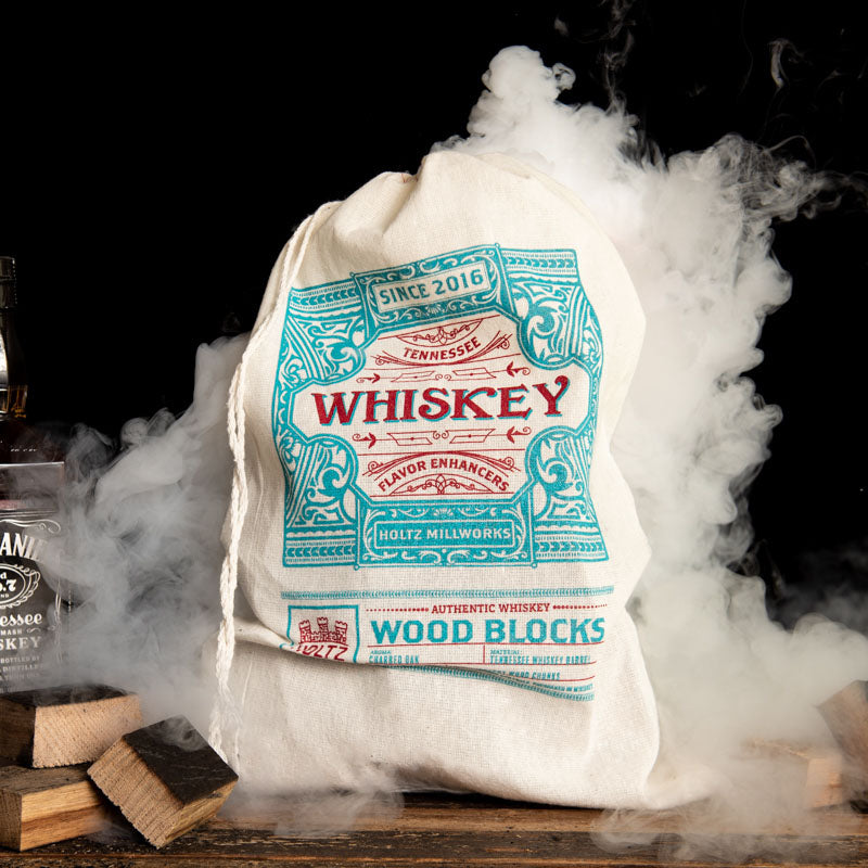 Wood block flavor enhancers from Tennessee Whiskey Barrel wood. In a white and blue bag