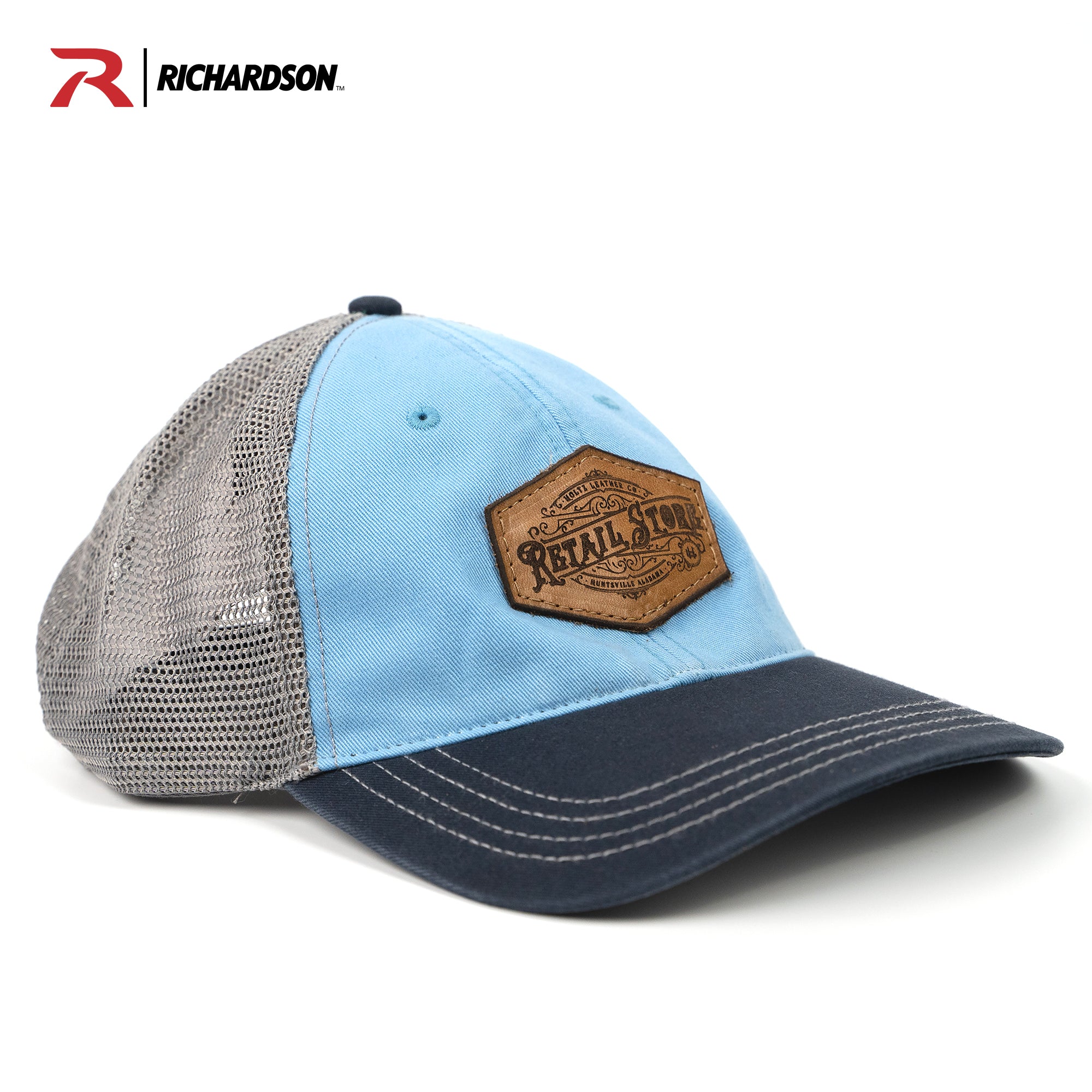 Blue and navy relaxed trucker hat with customized leather patch