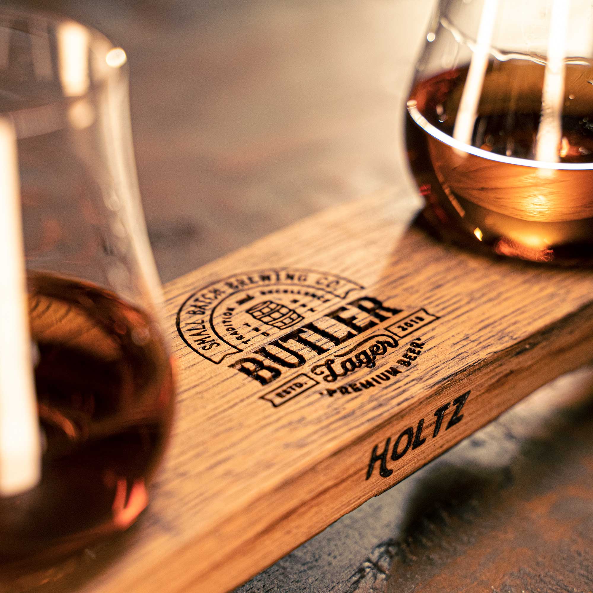Whiskey flight made of Tennessee Whiskey barrel stave with a personalized logo