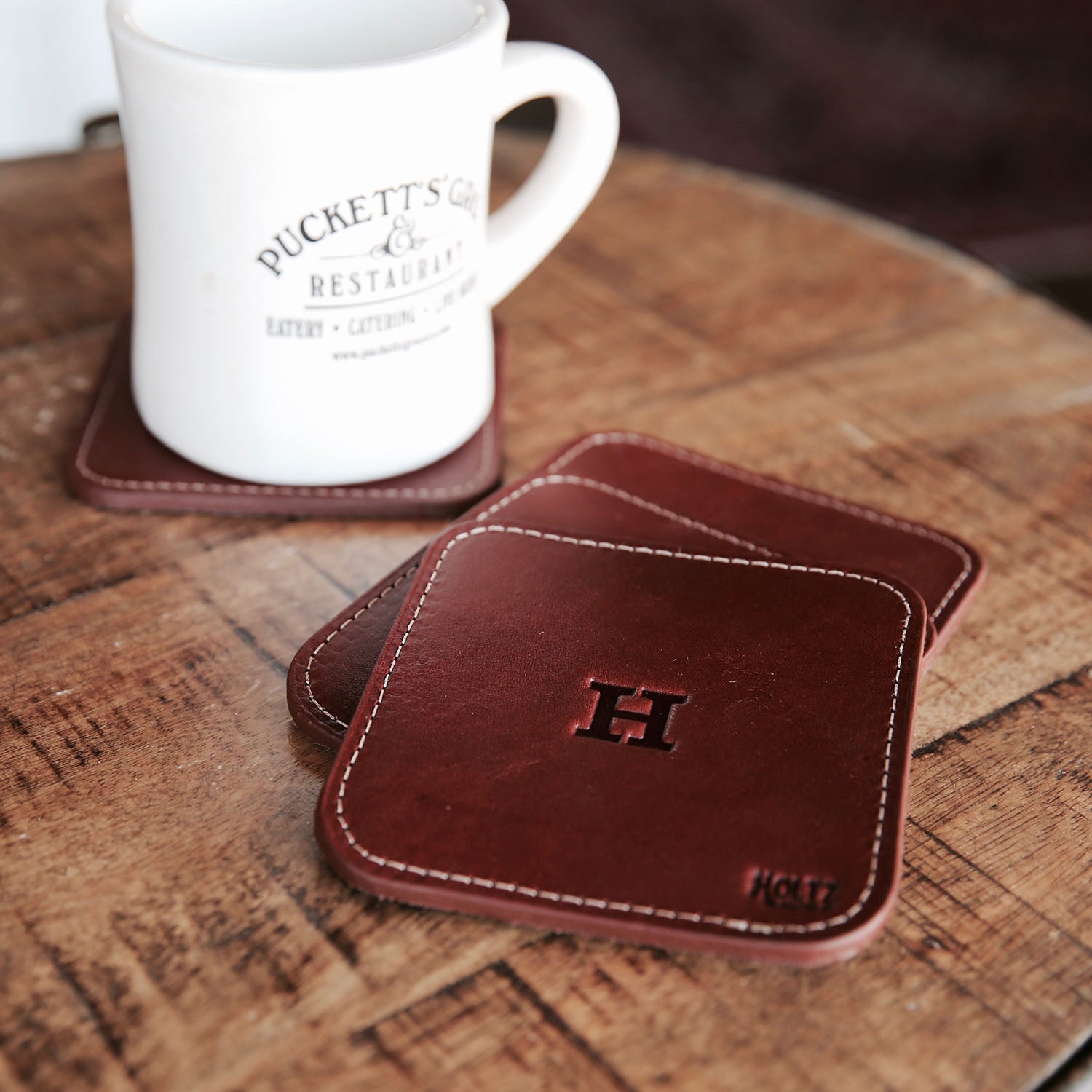 Full-grain single-stitch American leather personalized leather coasters. Available in dark brown, black, and chestnut. leather.  