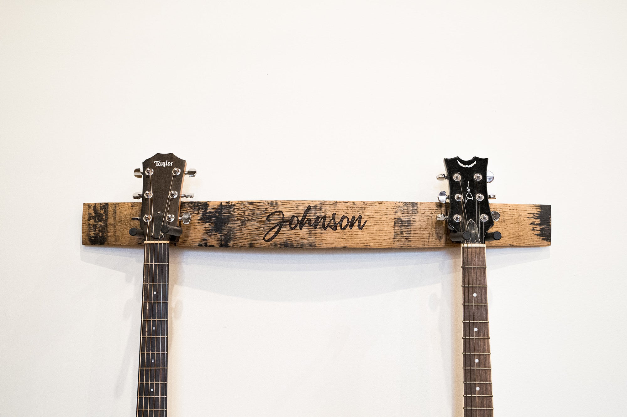 Double guitar holder made of Tennessee Whiskey Barrel with personalized name