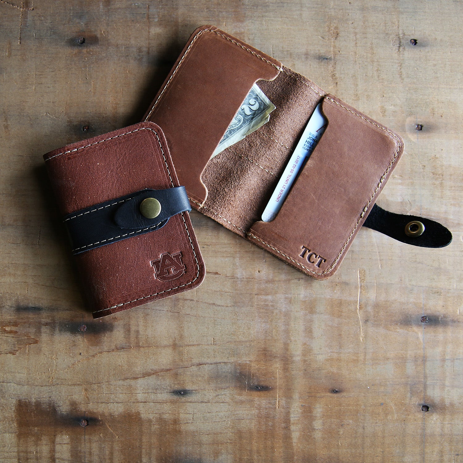 Fine leather snap closure bifold wallet with personalized initials and Auburn University logo