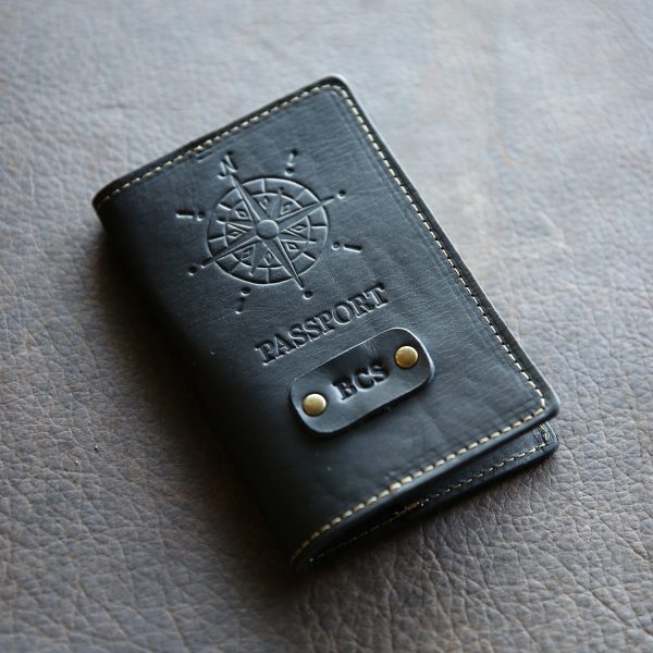 Black leather passport cover with compass imprint and personalized initials