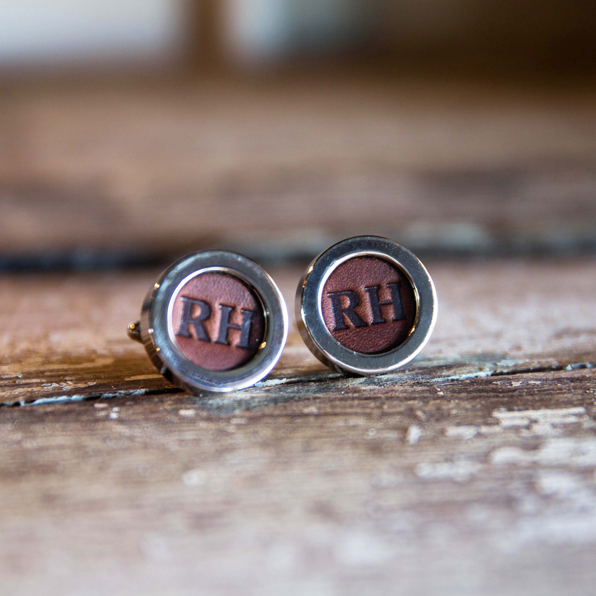 Fine leather cufflink with personalized initials being worn by a person