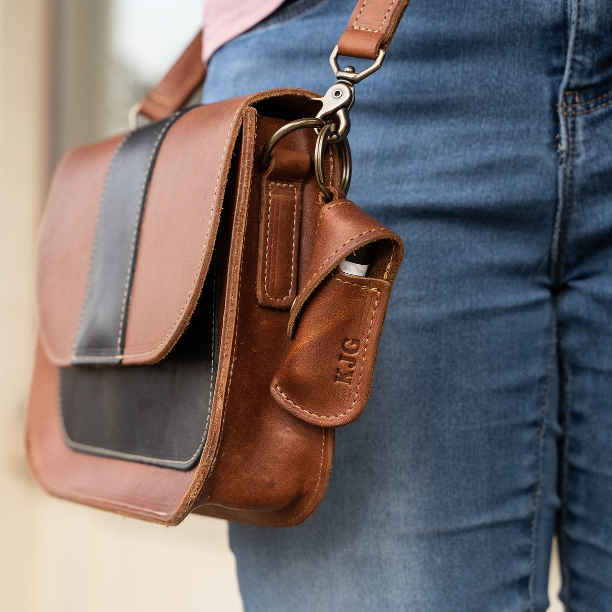 Keychain lip balm holder featuring button snap closure. Made with full-grain American leather. Customize with your initials. Makes for the perfect gift or stocking stuffer. Available in black or brown leather.
