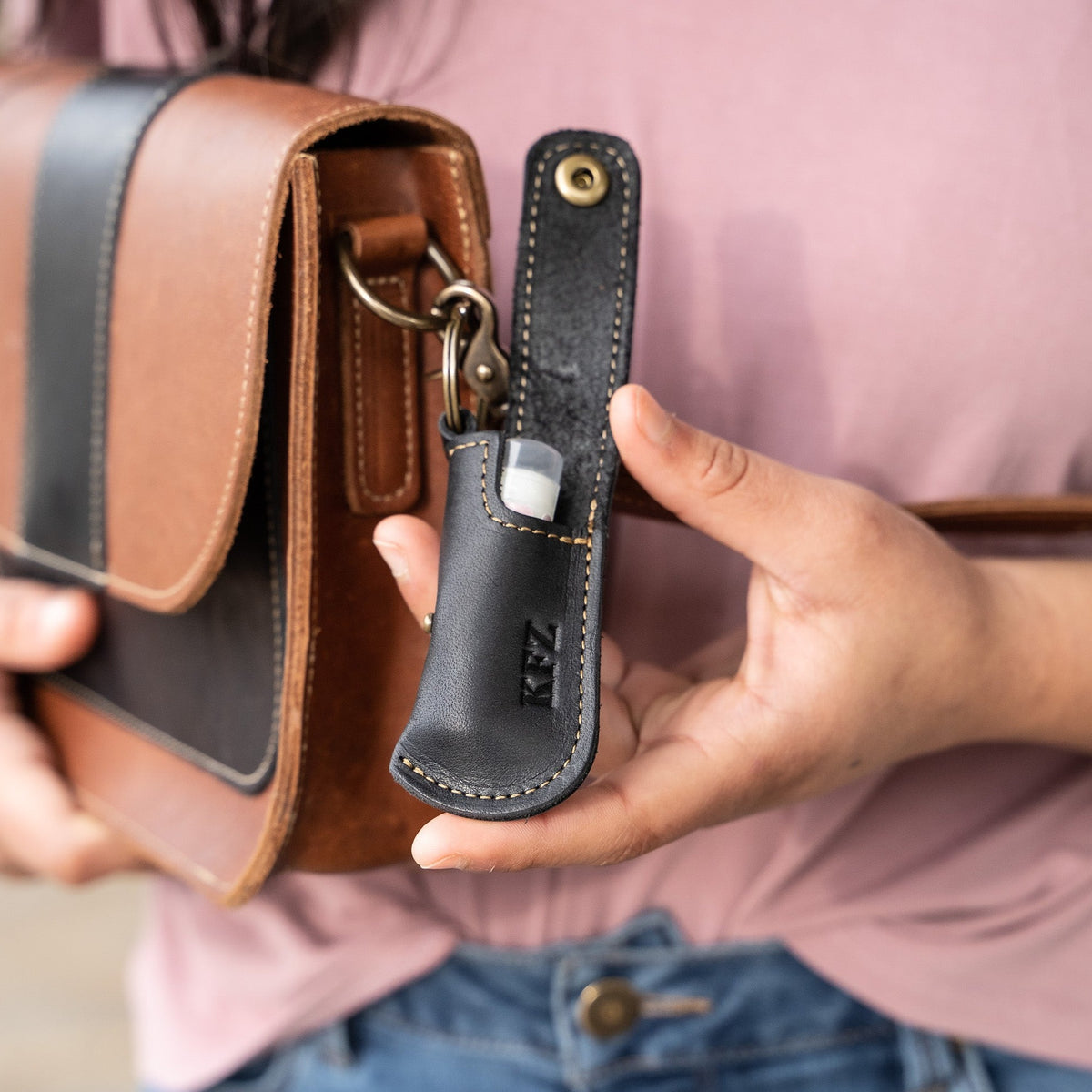 Keychain lip balm holder featuring button snap closure. Made with full-grain American leather. Customize with your initials. Makes for the perfect gift or stocking stuffer. Available in black or brown leather.