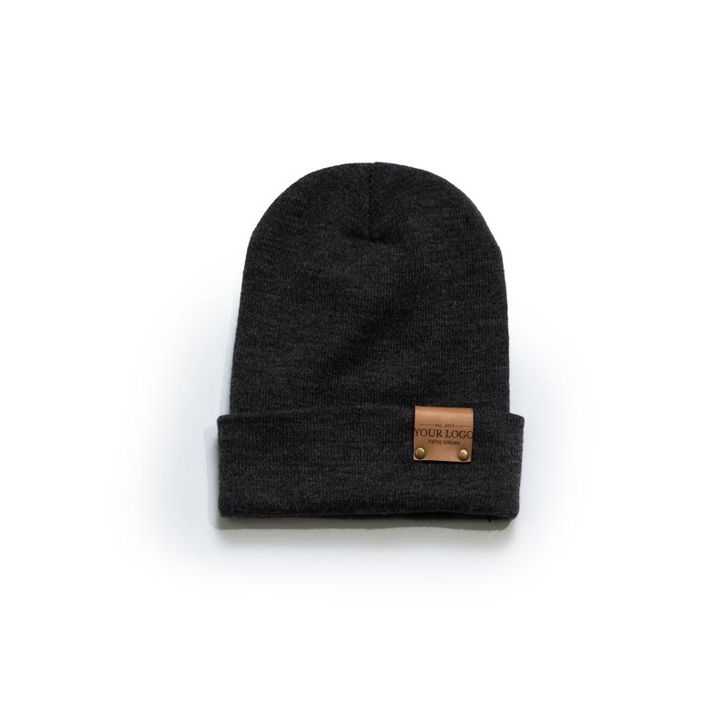 Person wearing heather beanie with custom logo leather patch