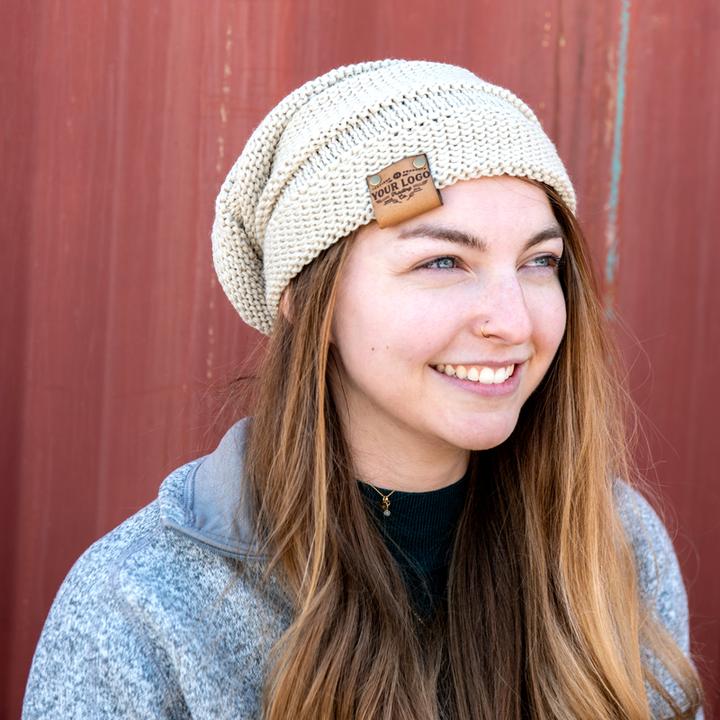 Person wearing Richardson 145 slouchy beanie with custom logo leather patch