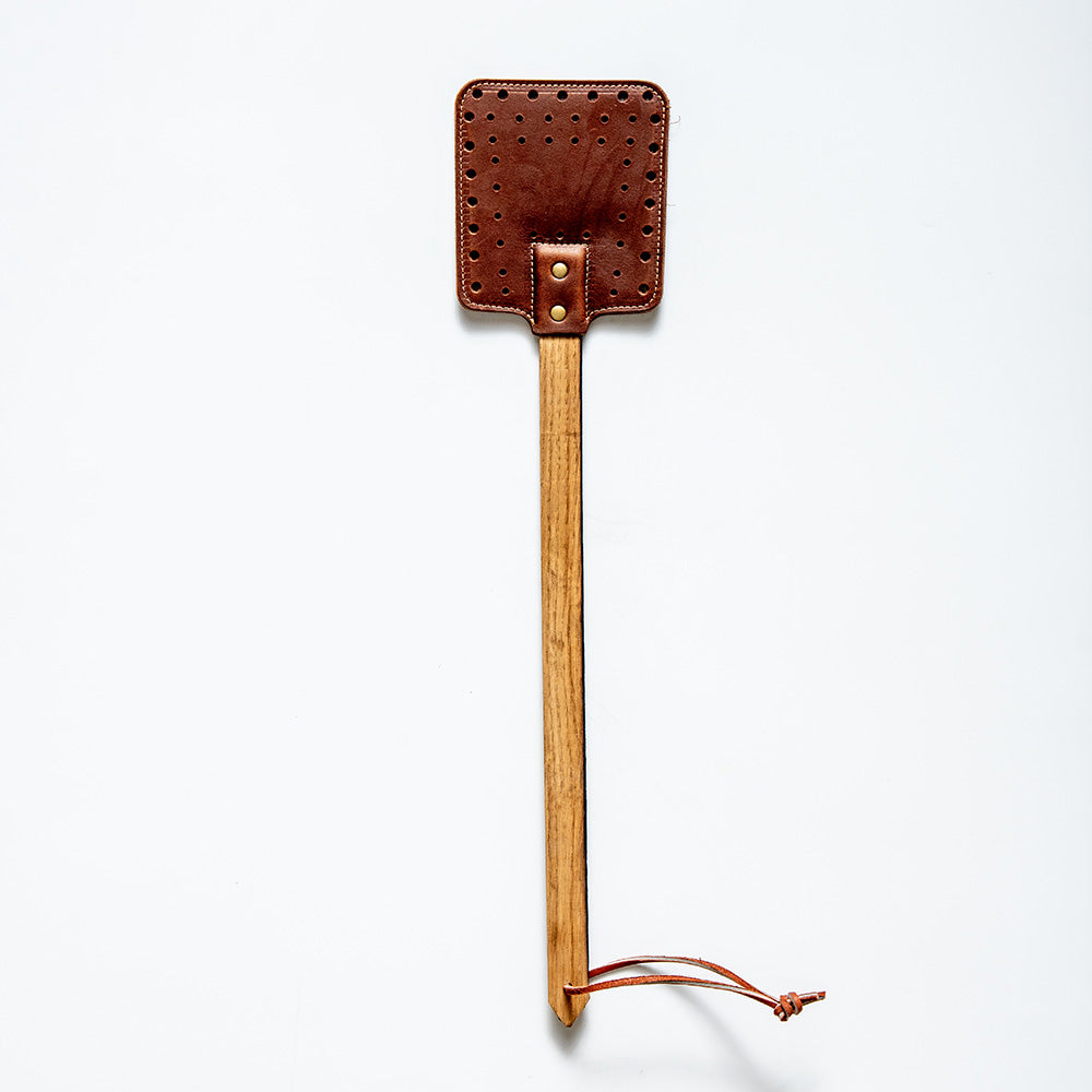 Leather flyswatters in black and brown with wooden handles made of Tennessee Whiskey Barrel
