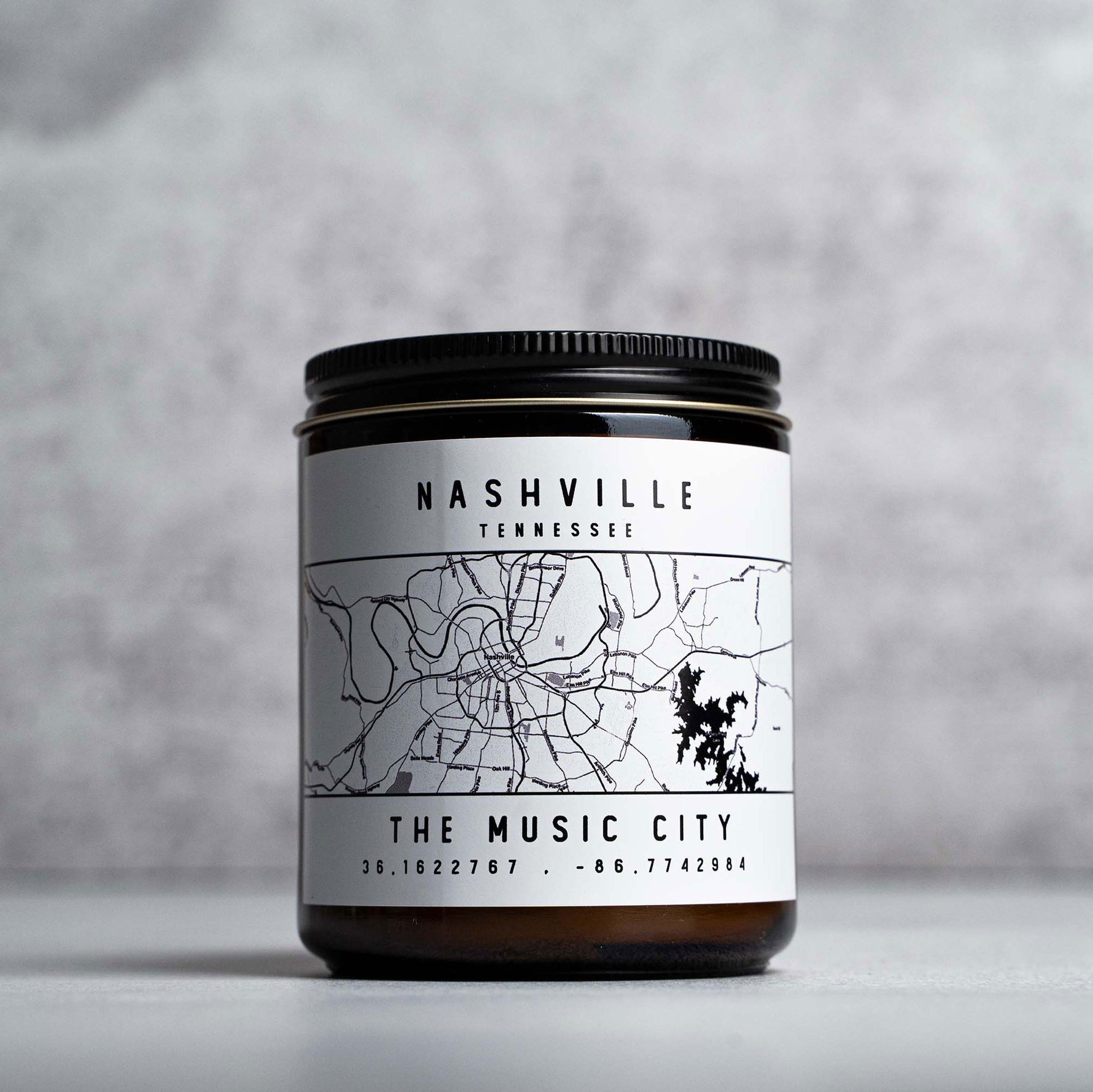 Candle in amber glass jar with Nashville, Tennessee The Music City map and coordinates