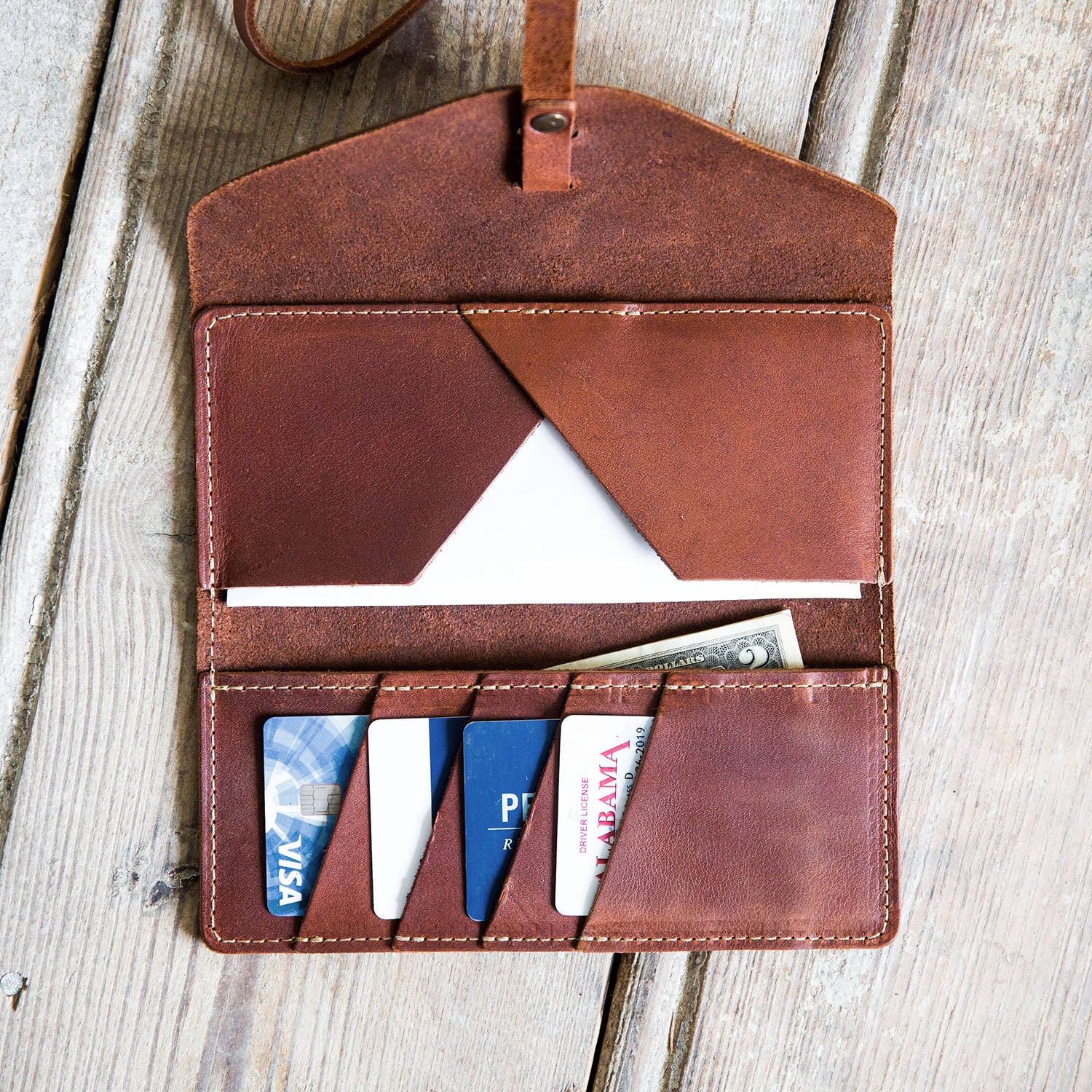 Fine leather pocketbook and checkbook with personalized initials and wrap closure from Holtz Leather Co in Huntsville, Alabama