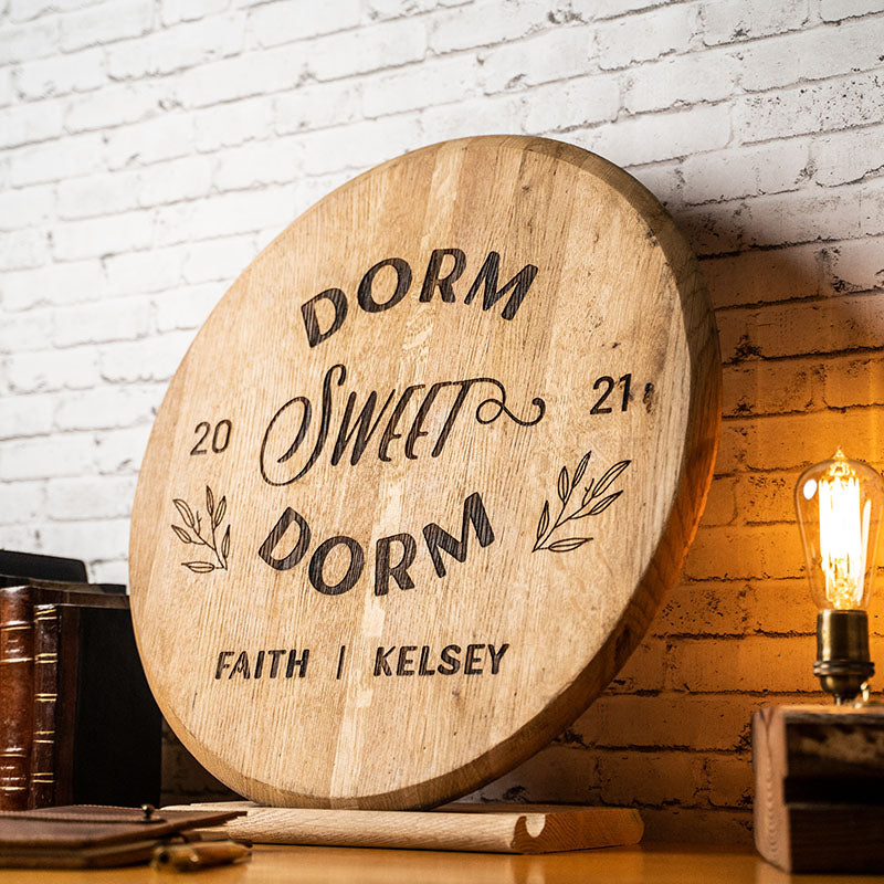Sign made of Tennessee Whiskey barrel head with "dorm sweet dorm" and personalized name and years written on it