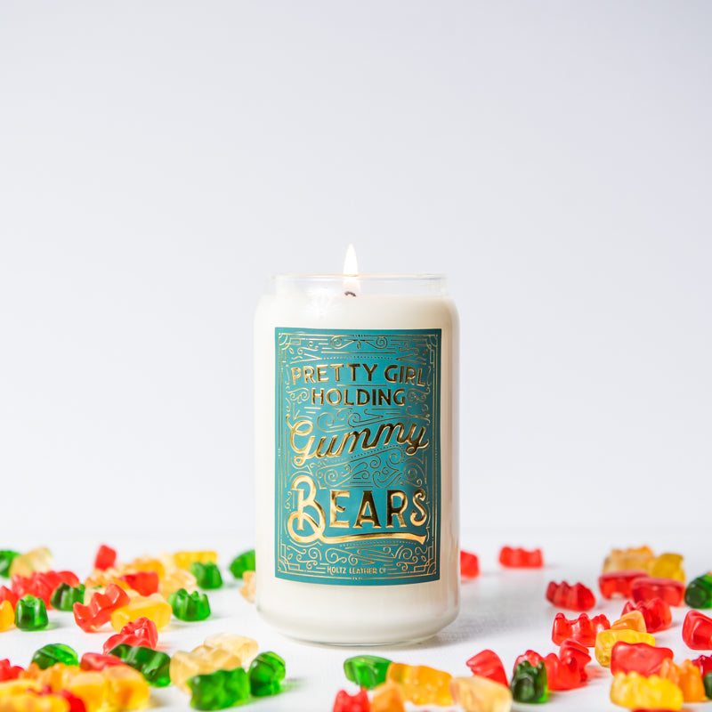 Pretty Girl Holding Gummy Bears scented candle in glass jar, surrounded by gummy bears