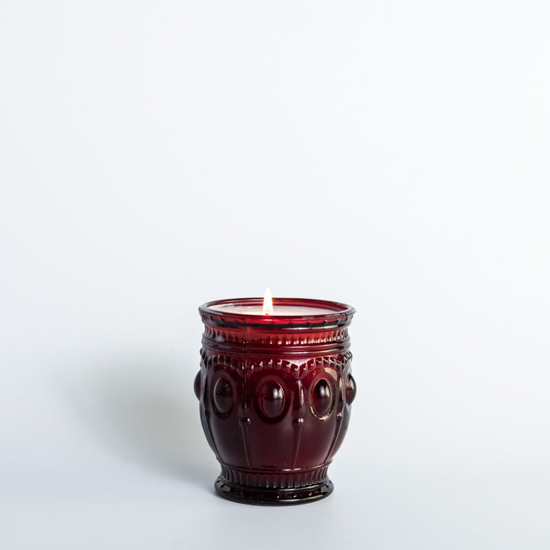 Saturday Morning scented candle in vintage red glass jar sitting on top of wooden table, hand-poured by Holtz Leather Co in Huntsville, Alabama