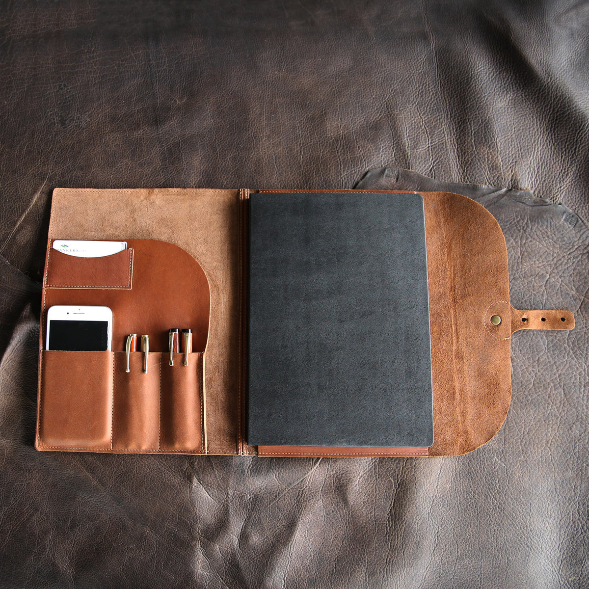 Open leather journal cover with notebook and pockets/folders from Holtz Leather Co in Huntsville, Alabama