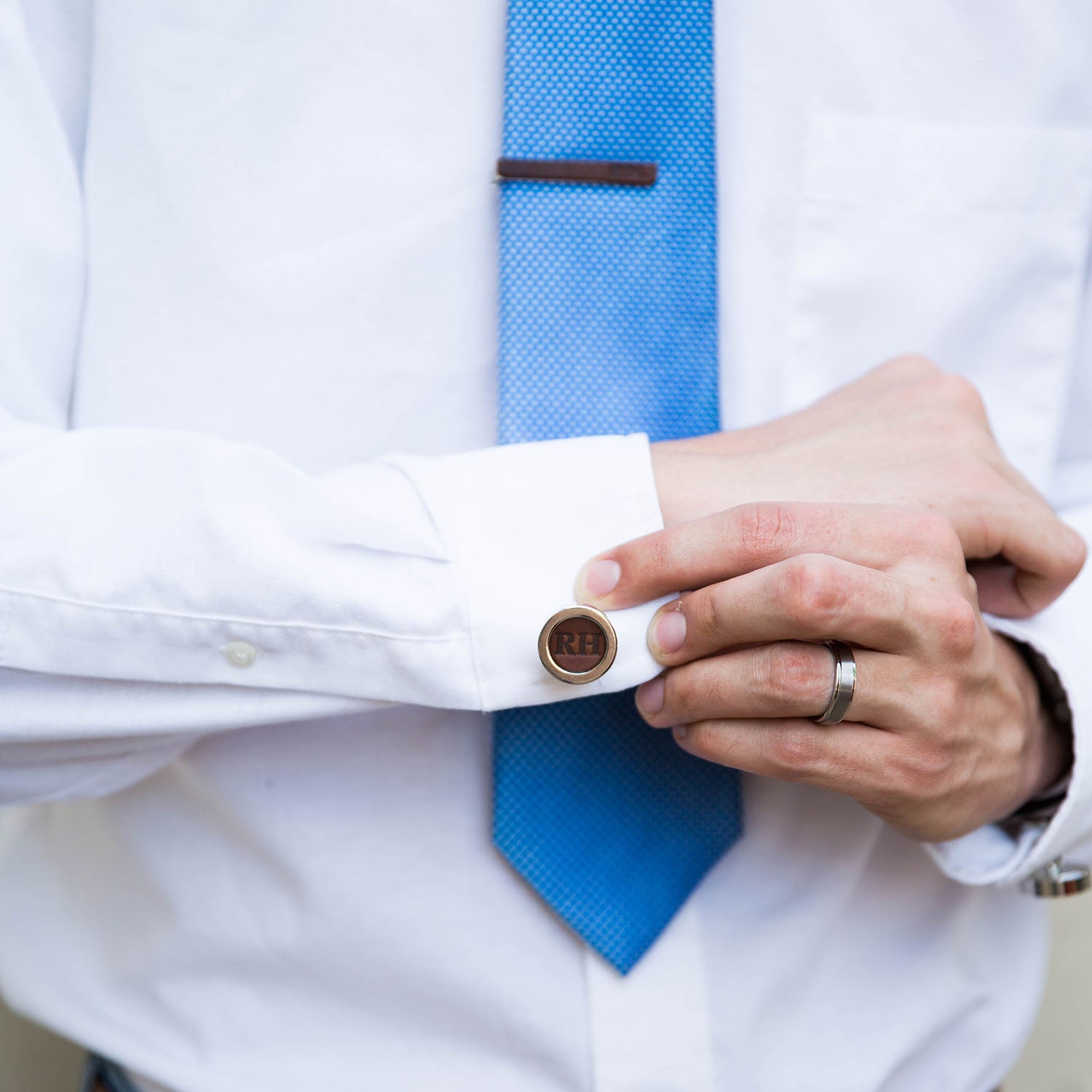Fine leather cufflink with personalized initials being worn by a person