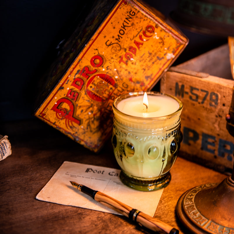 Tobacco and bay leaf scented candle in light green vintage style glass jar, hand-poured by Holtz Leather Co in Huntsville, Alabama