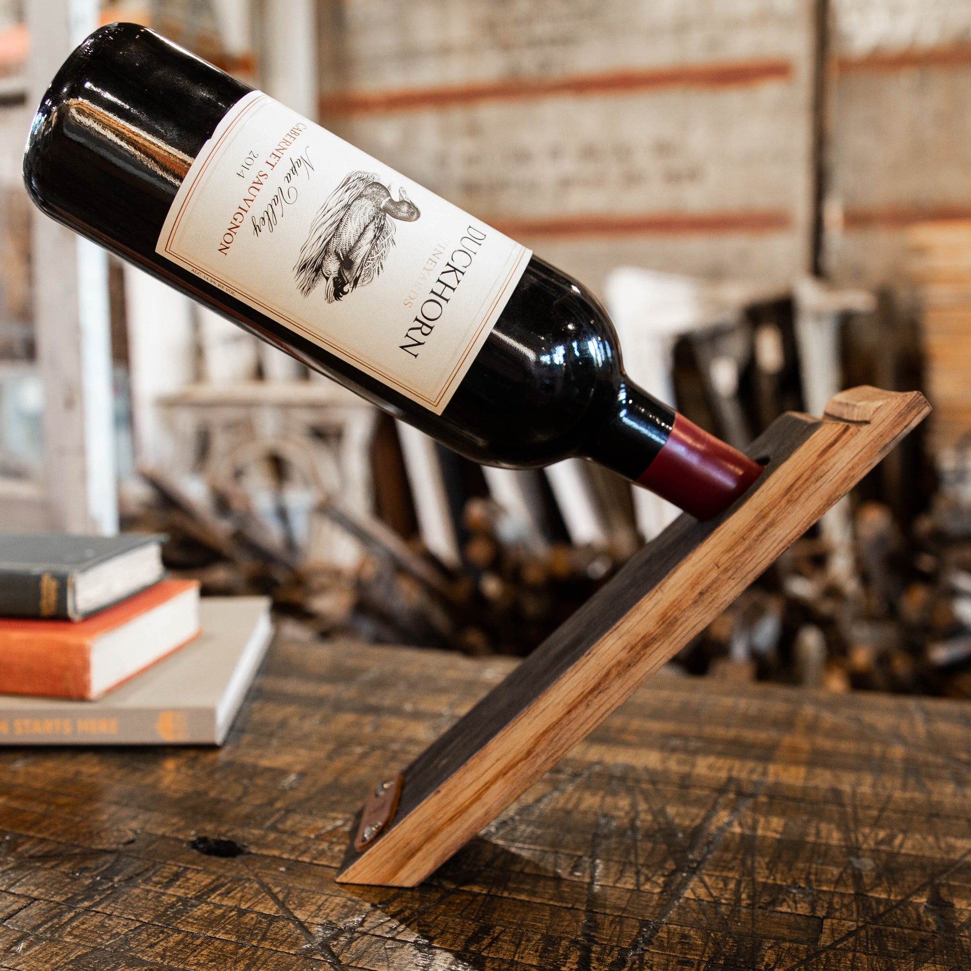 Floating wine bottle holder made from Tennessee Whiskey Barrel wood and handcrafted at Holtz Leather Co in Huntsville, Alabama
