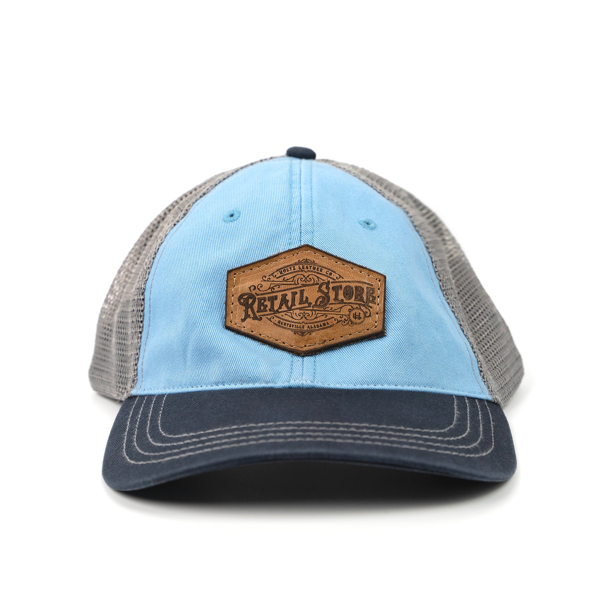Blue and navy relaxed trucker hat with customized leather patch